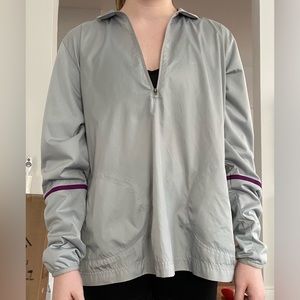 Lightweight, water resistant quarter zip with purple accent by Nike!